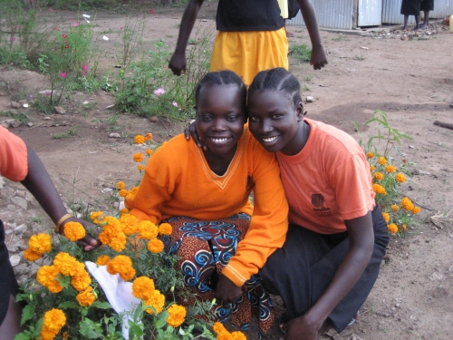 Students with flowers they have planted